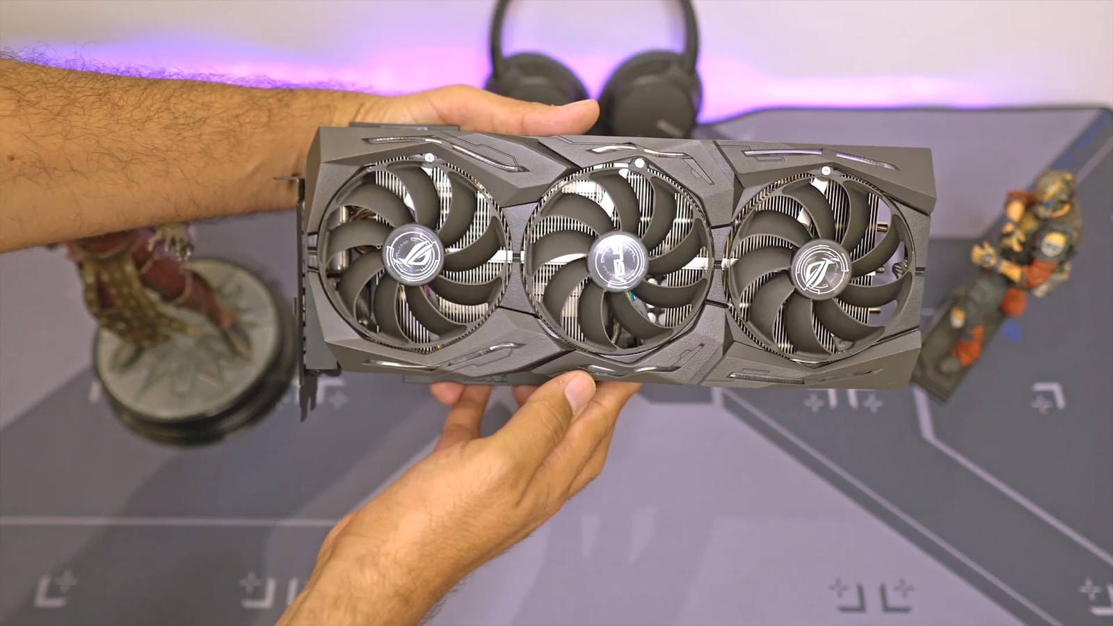 a person holding a computer fan in their hand